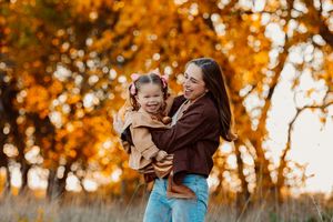 Candid family moments captured during Kansas golden hour in autumn foliage.