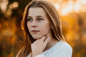 Warm autumn portrait with Kansas golden sunset lighting and natural outdoor backdrop.