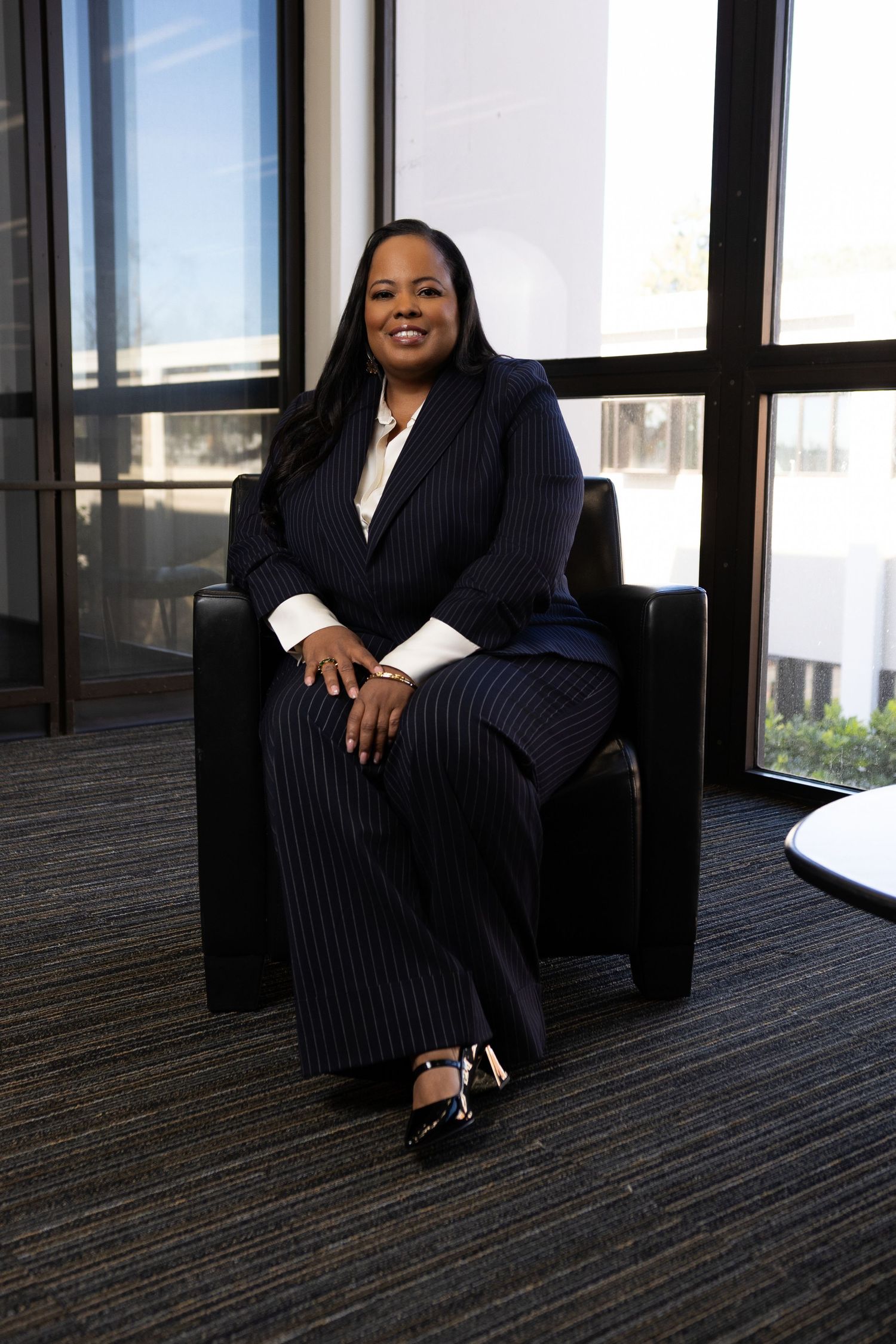Personal branding photoshoot in Long Beach showing female entrepreneur in professional office setting by Justicee Photography