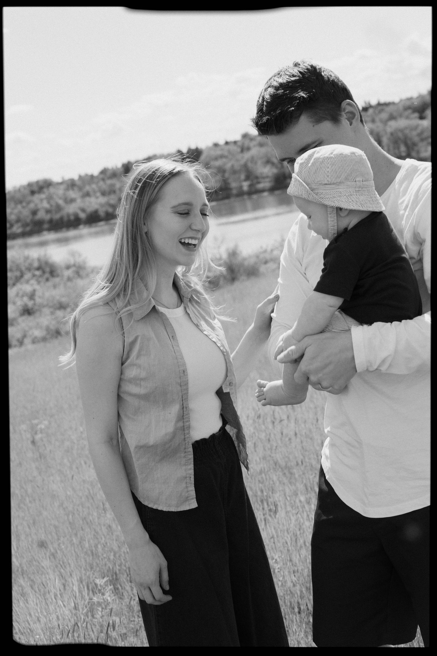 Black and white photo of joyful moment with small child in outdoor setting.