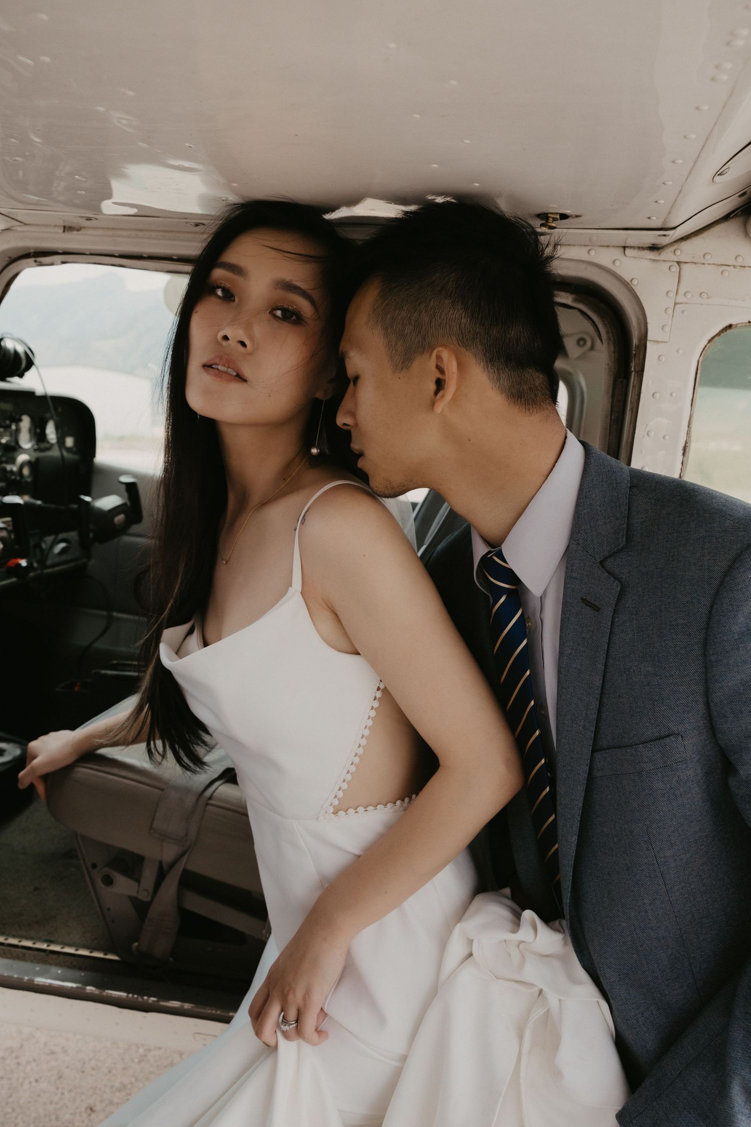 A romantic moment captured inside a vintage aircraft cabin.