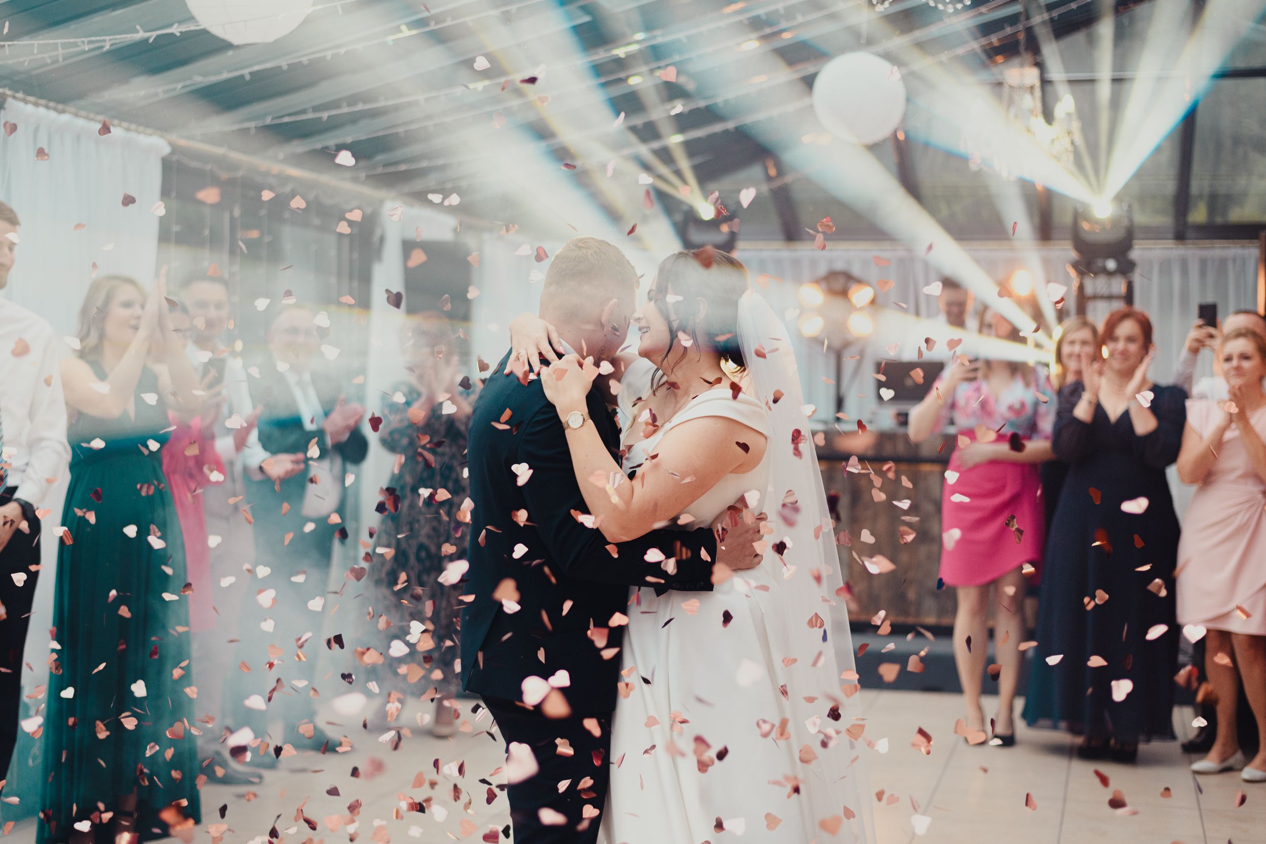 Wedding celebration with confetti and sparklers creating magical atmosphere indoors.