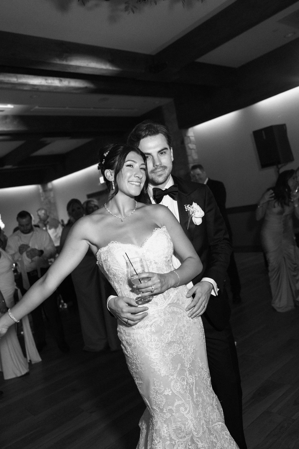 A joyful couple dances together at their wedding reception.