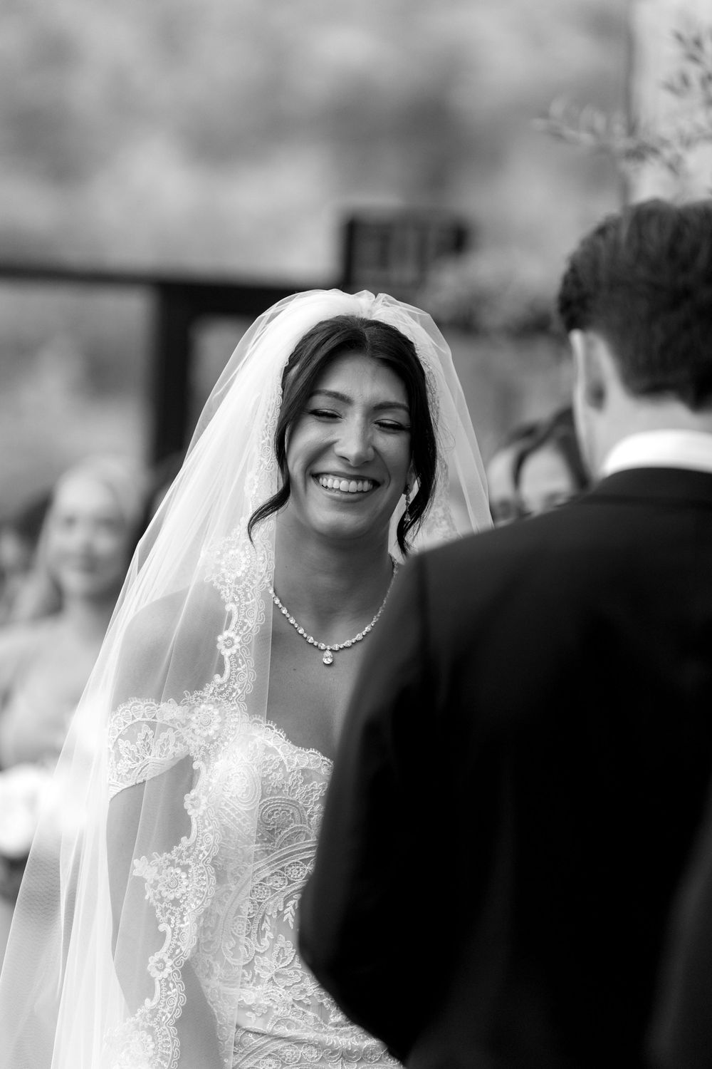 Black and white candid photo capturing a genuine moment during wedding vows.