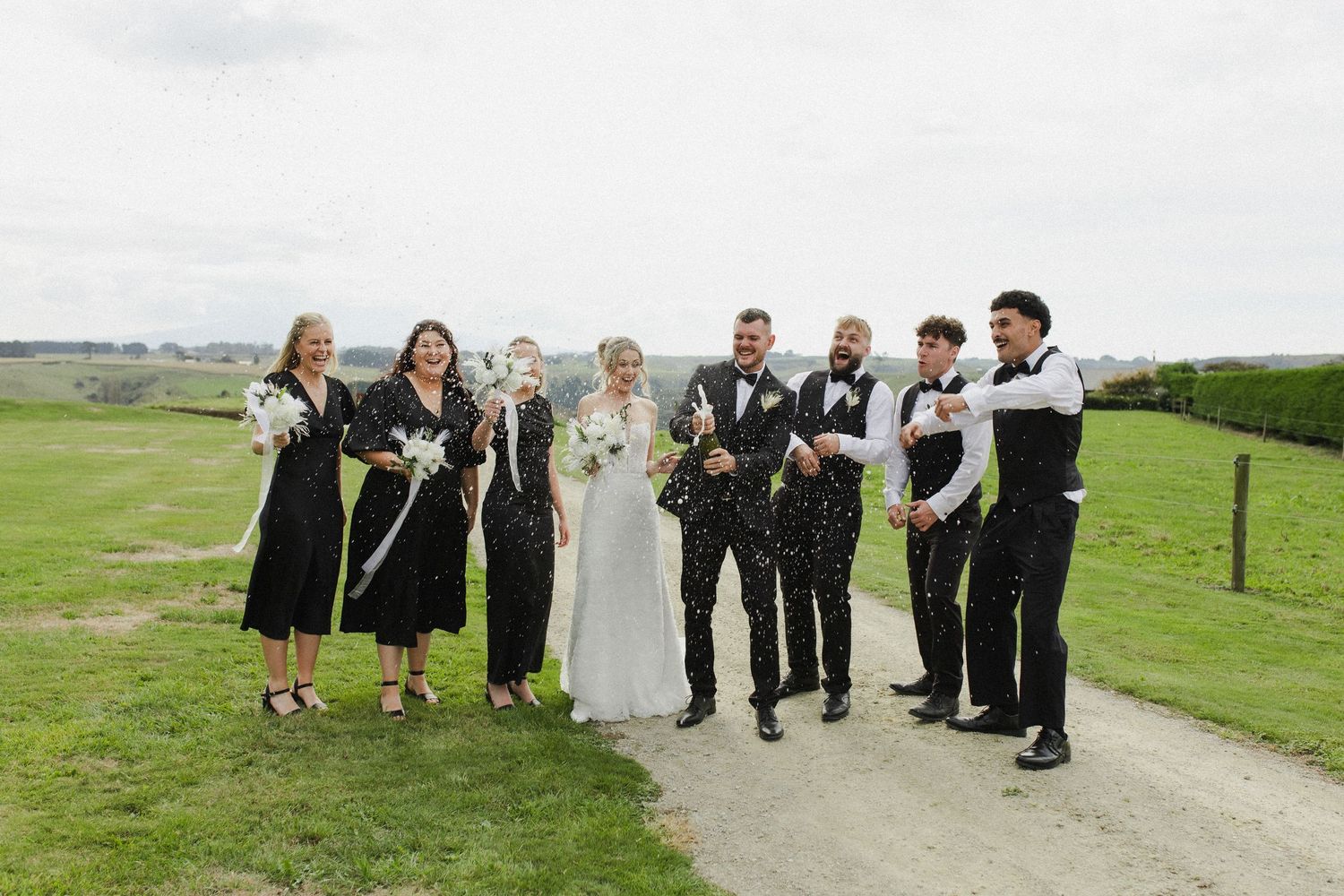 Bridal party doing a champagne pop