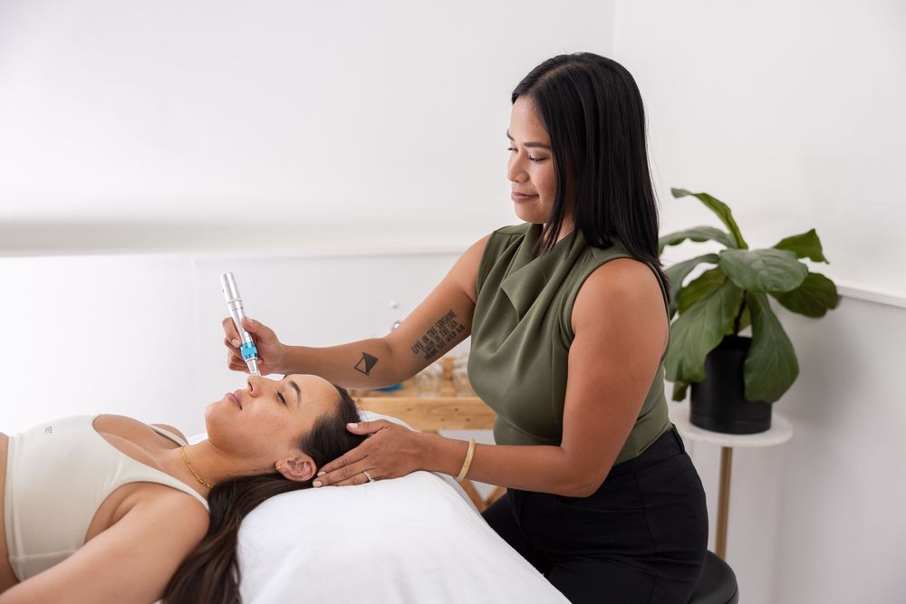 woman acupuncturist branding photo in Issaquah, WA with client acupressure treatment using tools on woman's face during seasson