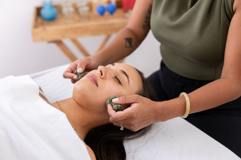 woman acupuncturist branding photo in Issaquah, WA with client acupressure treatment using facial cups on woman
