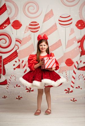 Red and white Christmas scene with candy cane decorations, lollipops and swirl backdrop, featuring holiday gift scene.