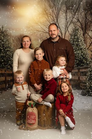 Festive holiday family portrait series with winter backdrop and falling snow effect in warm earth tones.