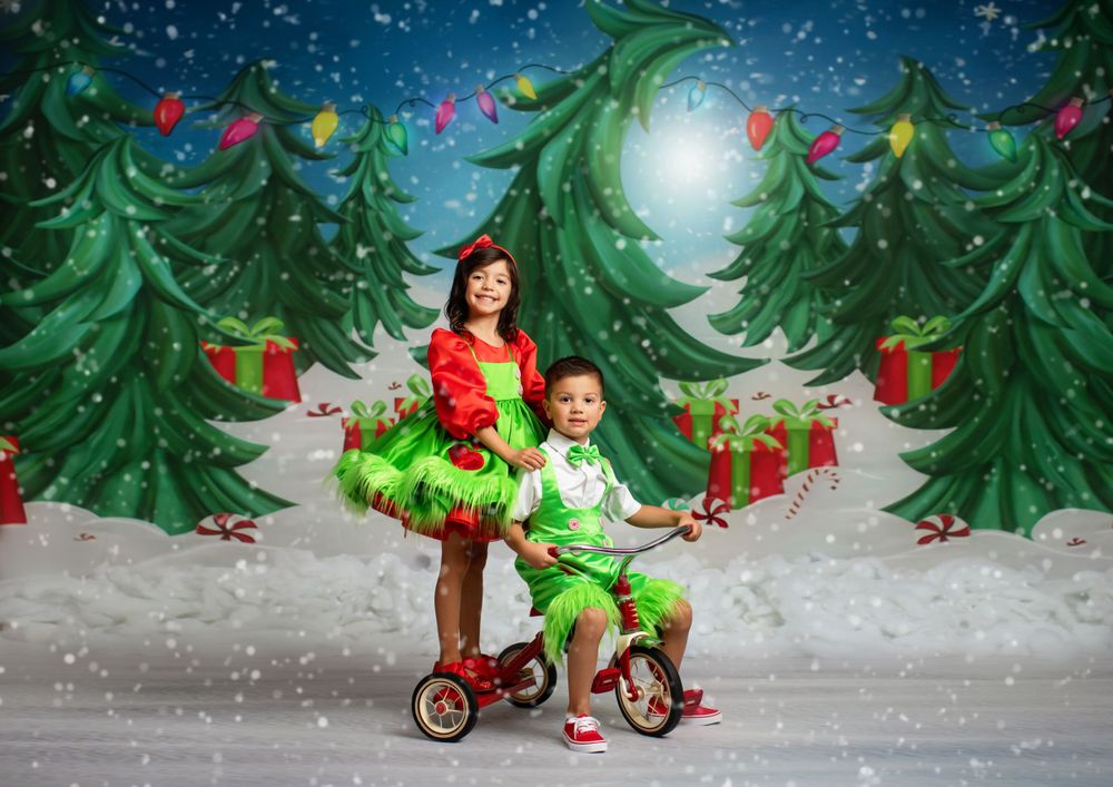 Whimsical Christmas setting with tricycle and decorated evergreen trees.