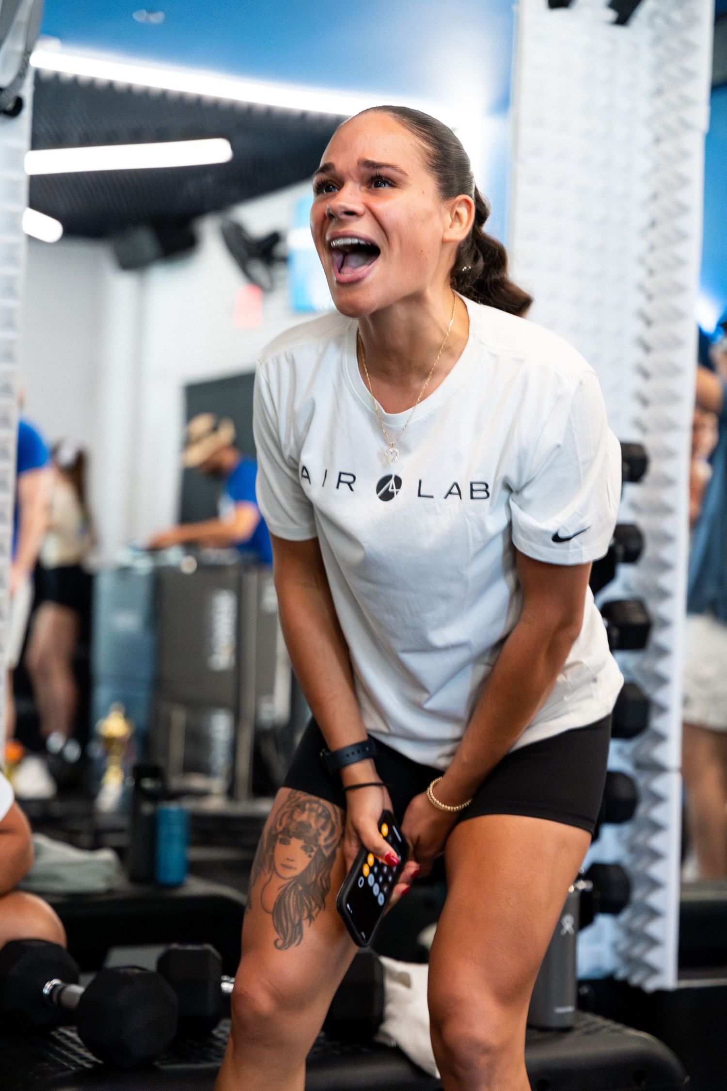 Athlete laughing during workout session while wearing Air Lab branded t-shirt.