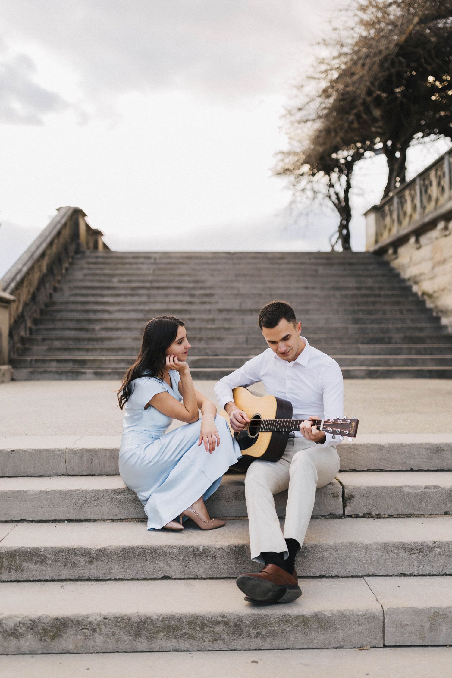 guy plays guitar to a girl on date night session
