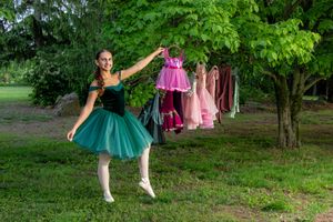 Ballerina in green tutu poses gracefully outdoors near past ballet Costumes Salem and Gloucester County senior Poraits