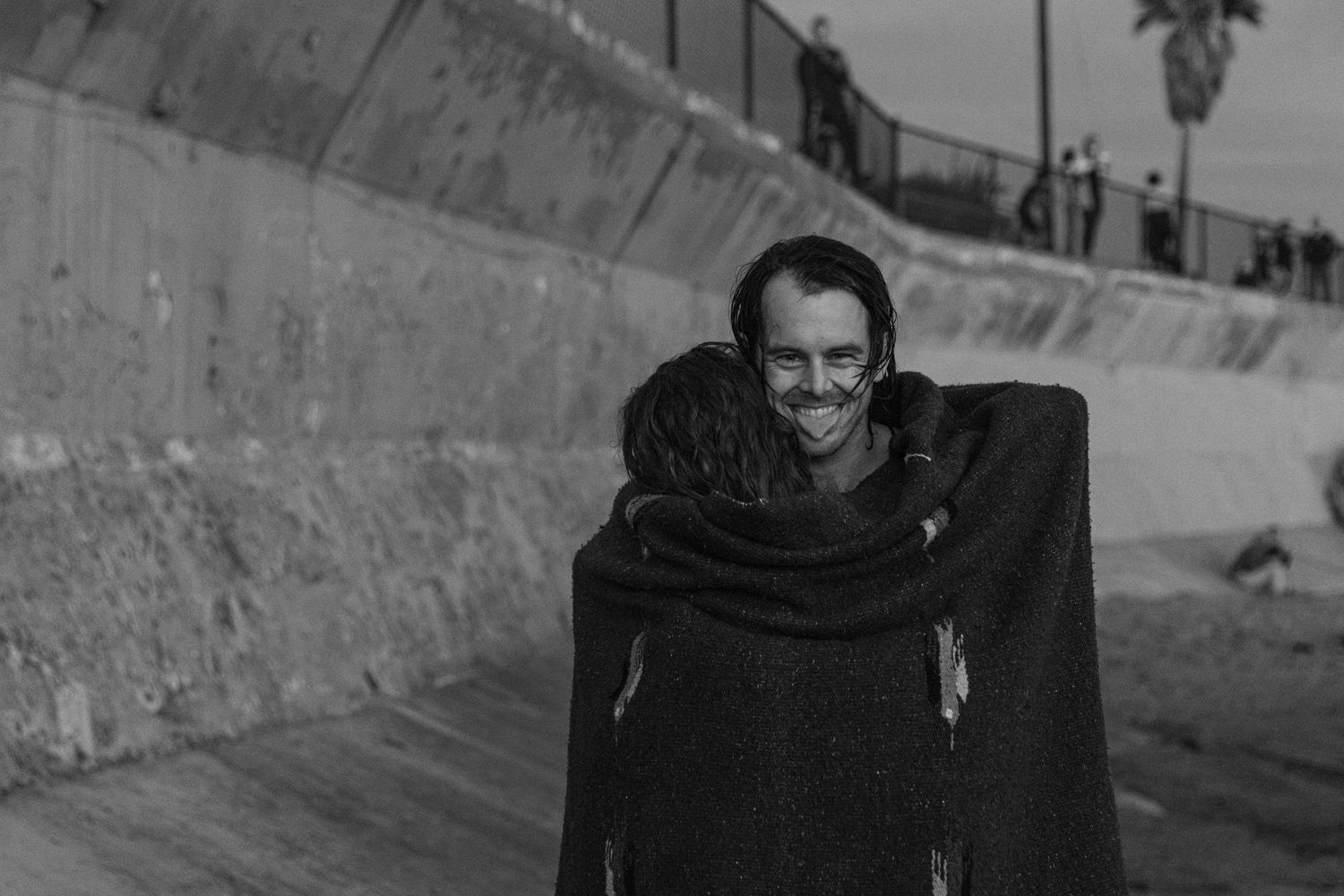 Black and white portrait against concrete wall outdoors.