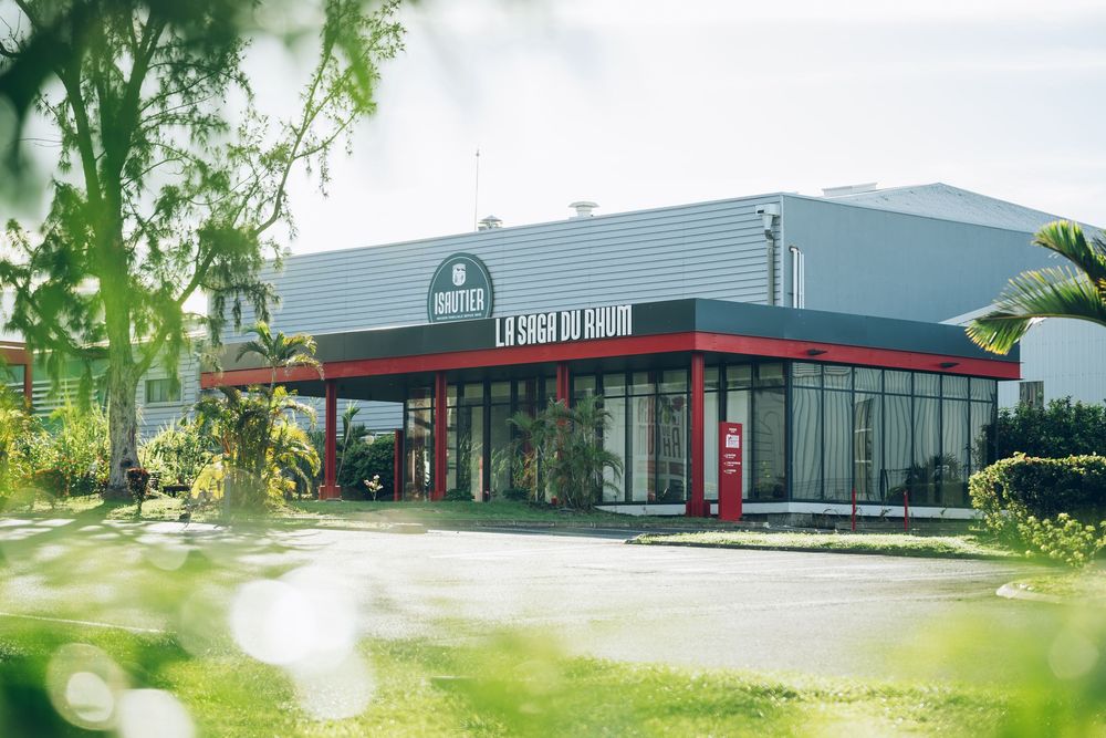 Modern commercial drive-through restaurant building with red trim and landscaping visible in foreground.