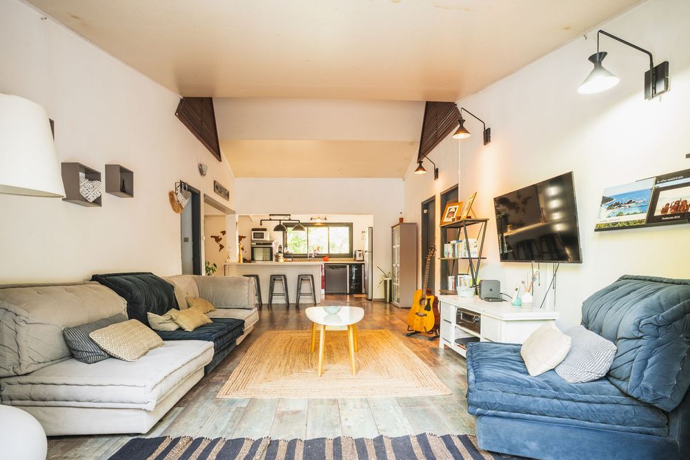 A contemporary loft apartment interior with natural lighting showcases sleek furniture and an open floor plan design.