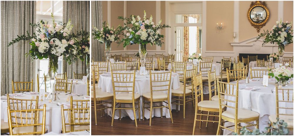 Elegant wedding reception venue with gold chiavari chairs and white floral centerpieces arranged in a banquet style setup.