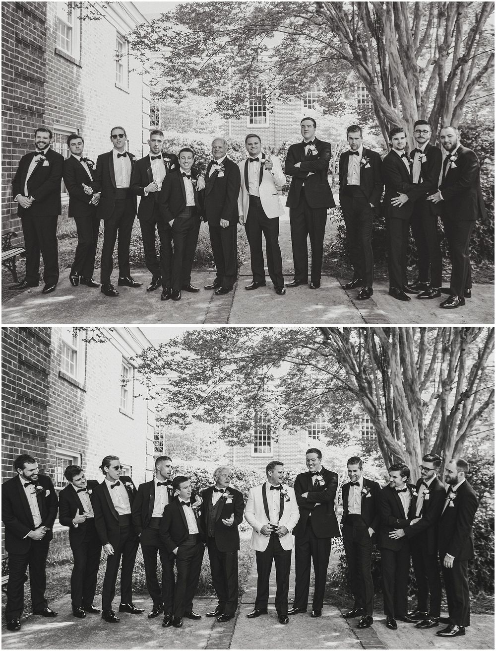 A large group of wedding guests in formal black and white attire stand together for a group photo outdoors.