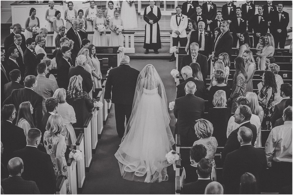 Black and white panoramic collage showing a formal wedding ceremony with guests gathered in an elegant venue.