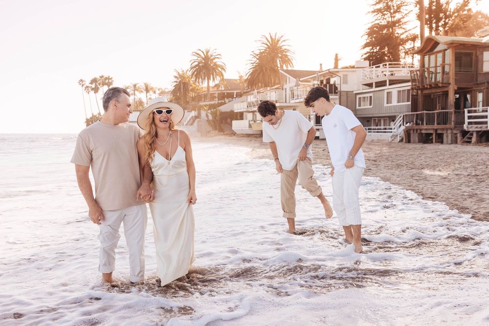 A romantic beach photoshoot sequence at sunset with couples walking along the sandy shoreline in light colored attire.