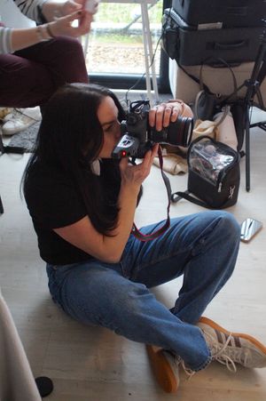 A sequence of shots showing a photographer crouching low to take photos on a wooden floor.