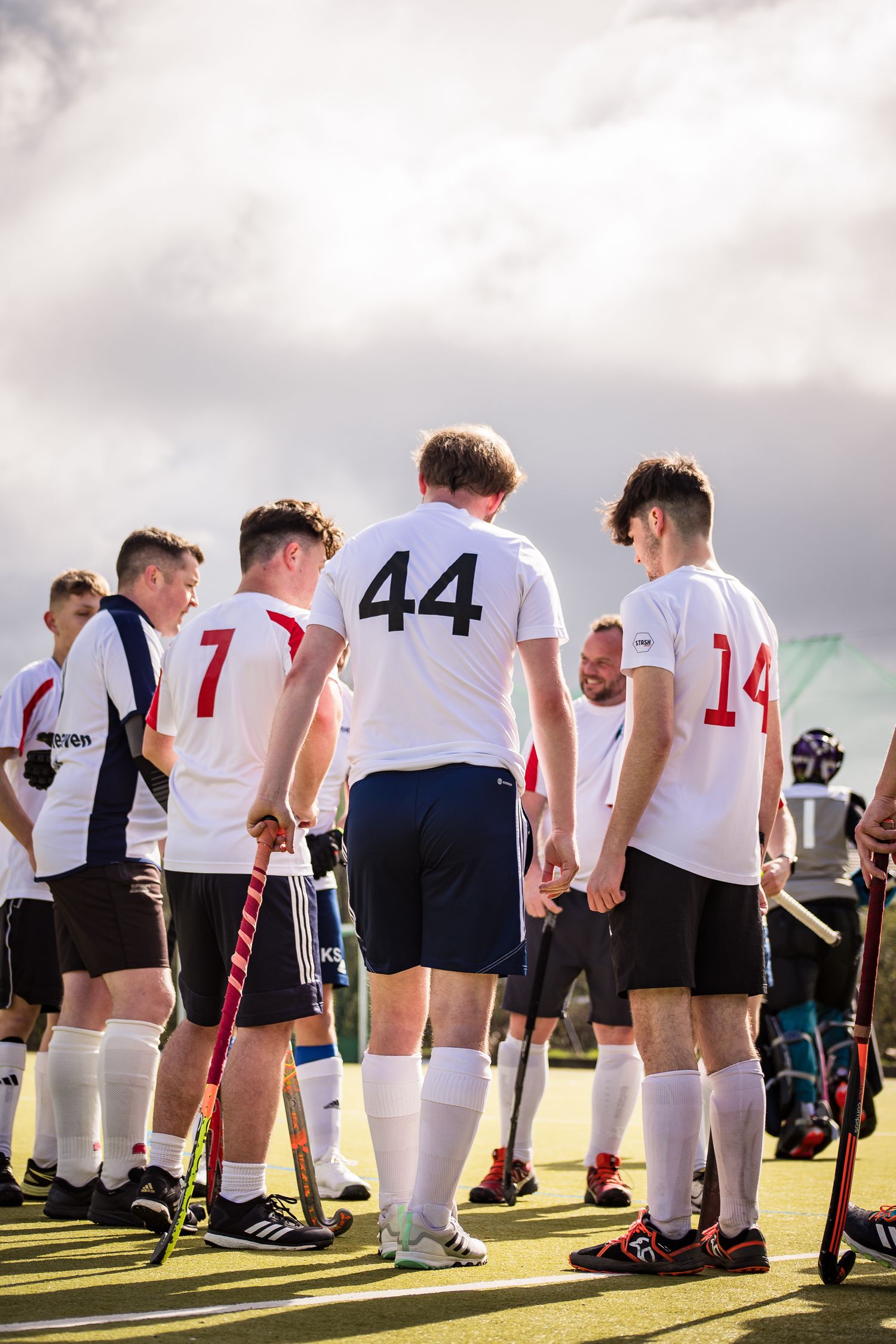 Huddle of Redditch Hockey players on their league winning game of the season