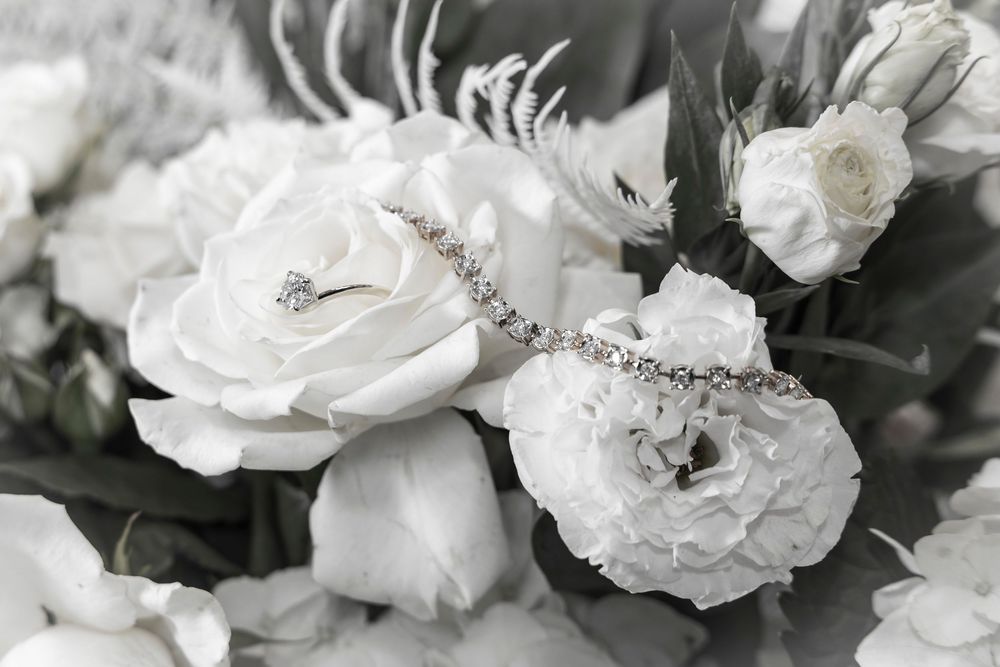 Delicate white roses with soft petals arranged in a detailed monochromatic composition.