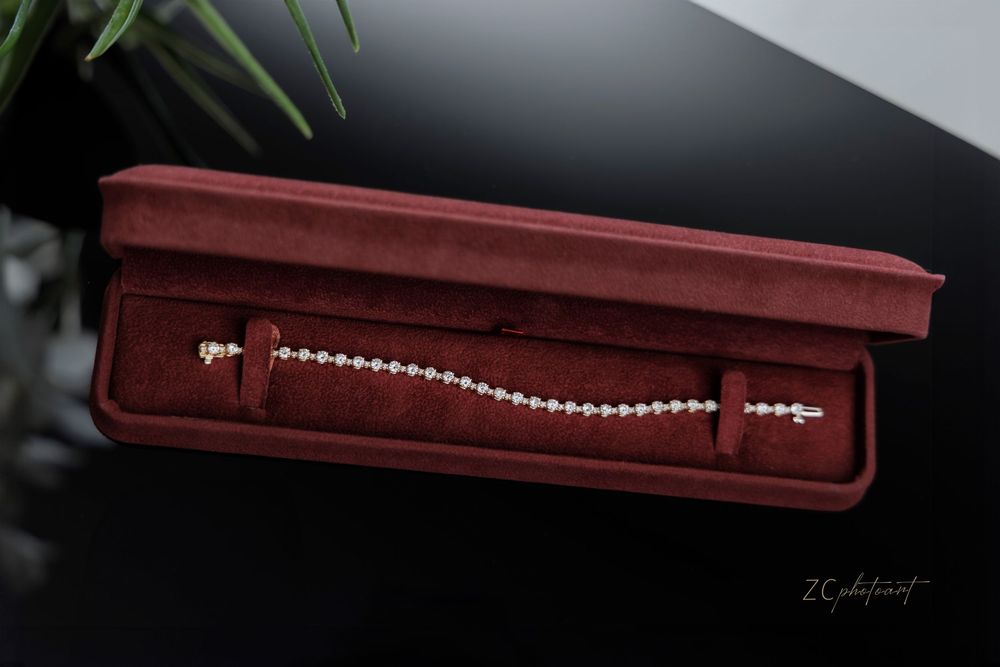 Elegant pearl necklace displayed in a burgundy velvet jewelry box with multiple angles showing the presentation.