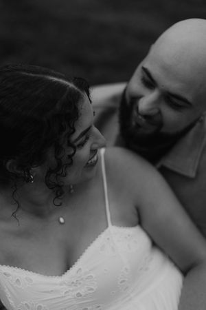 Black and white intimate portrait of a loving couple on their wedding day sharing a tender moment.