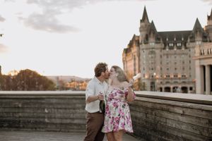 A romantic moment shared against the backdrop of the Chateau Laurier at sunset.