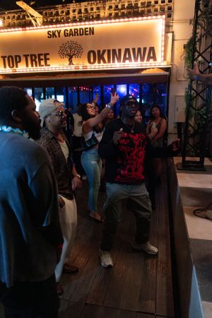 Nightlife scene at Sky Garden Top Tree Okinawa with people dancing under venue lights.