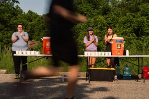 Volunteers at an aid station, branding photos for a timing company.