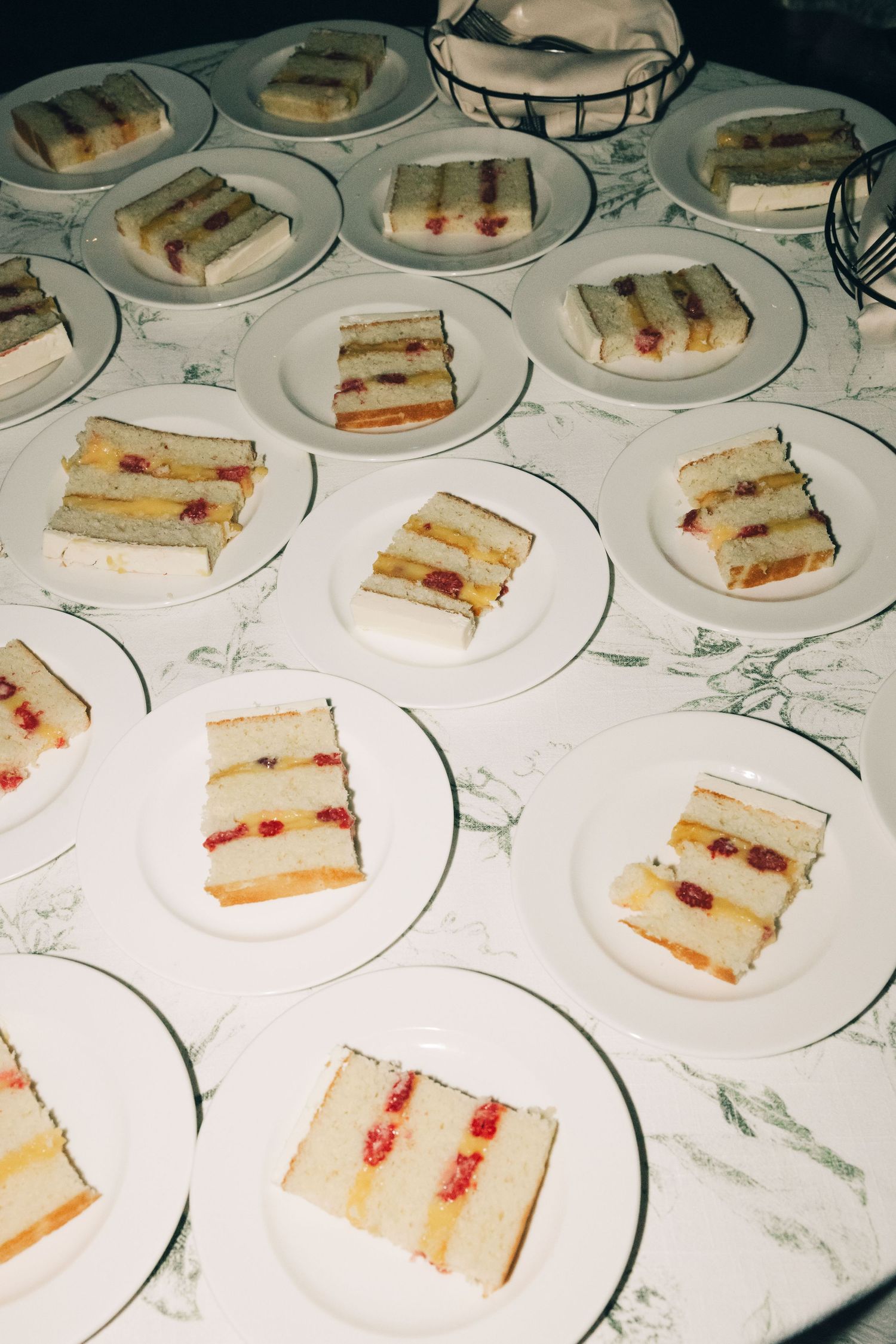 Multiple plates of layered sandwich triangles arranged on white marble surface.