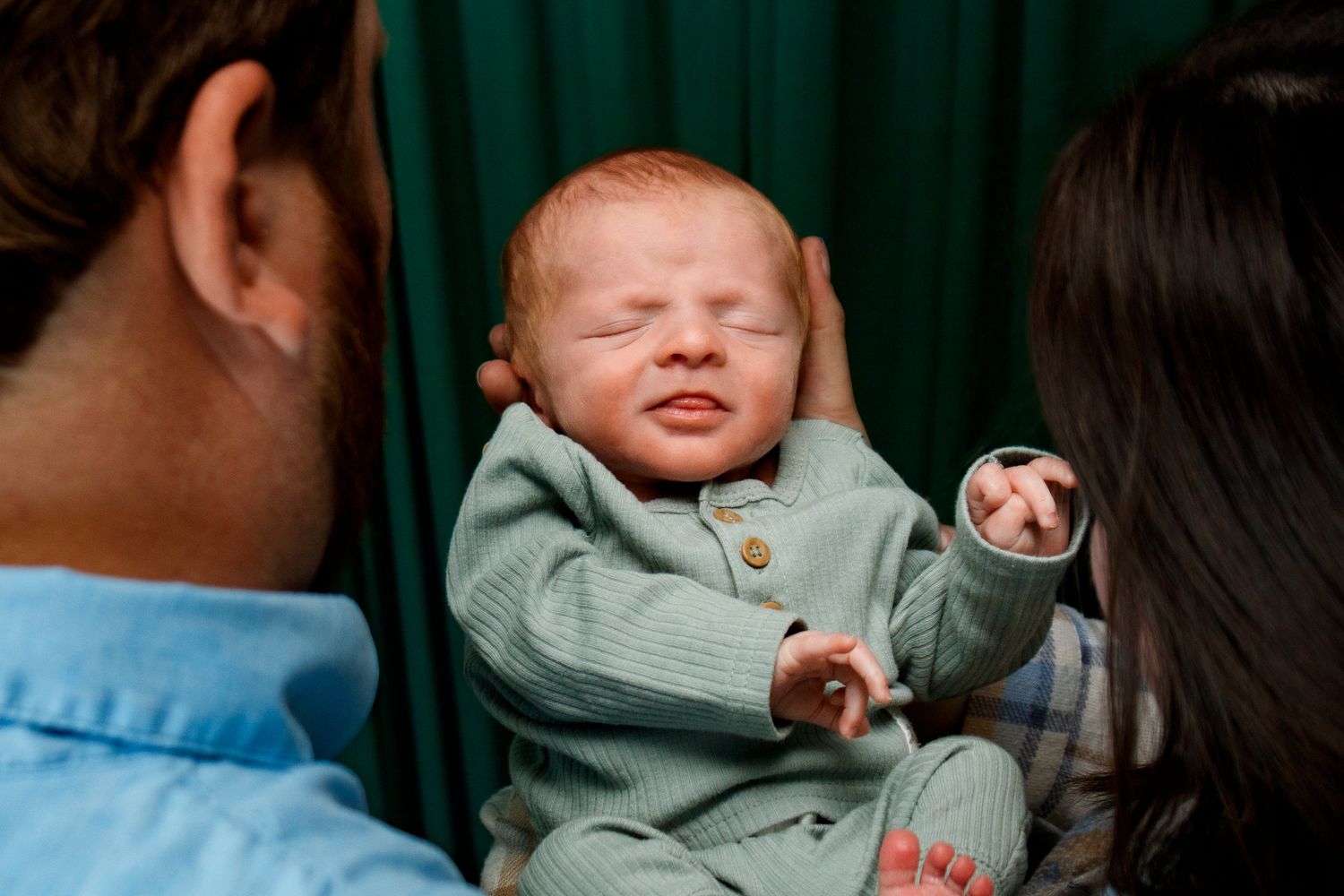 A family of three during a newborn photo session at a studio in Amarillo, Texas