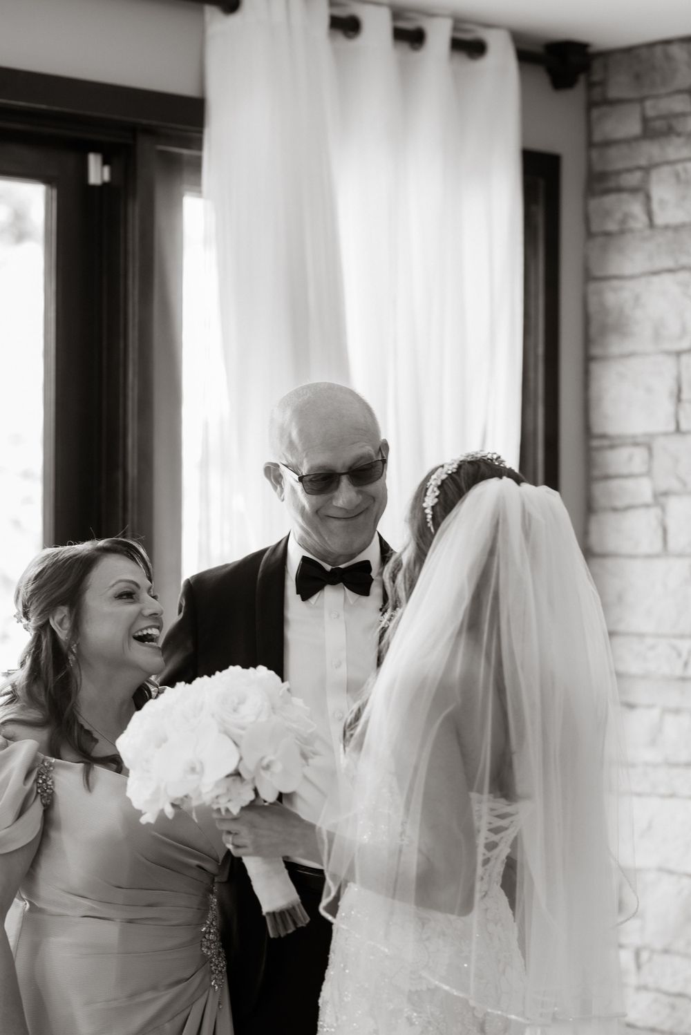 Black and white candid moments captured during wedding day preparations.
