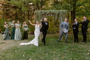 bride and groom celebrate during marriage ceremony at Farmer Brown's Greenhouse, Moncton wedding photographer outdoor fall wedding Canada