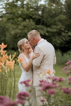 Bride and groom kiss during intimate wedding portraits in Cormier Village, New Brunswick wedding photography natural light photographer