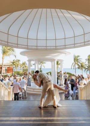 Bride and groom wedding dip kiss at end of aisle wedding ceremony beach resort Riviera Maya Mexico destination wedding photographer packages