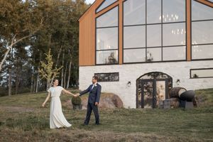 Bride and groom walking hand in hand at sunset Cidery at 51 Acres wedding Moncton photographer New Brunswick wedding professional freelance