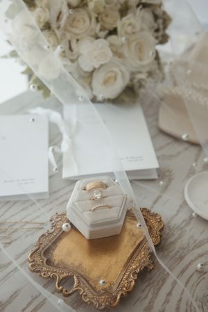 fine art detail flat-lay wedding photography in New Brunswick, pearl veil with antique gold tray, trendy wedding detail photography Moncton