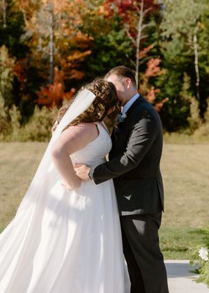 bride and groom's first kiss wedding ceremony photography at the Grand Ivory outdoor fall wedding in Moncton wedding photography NB