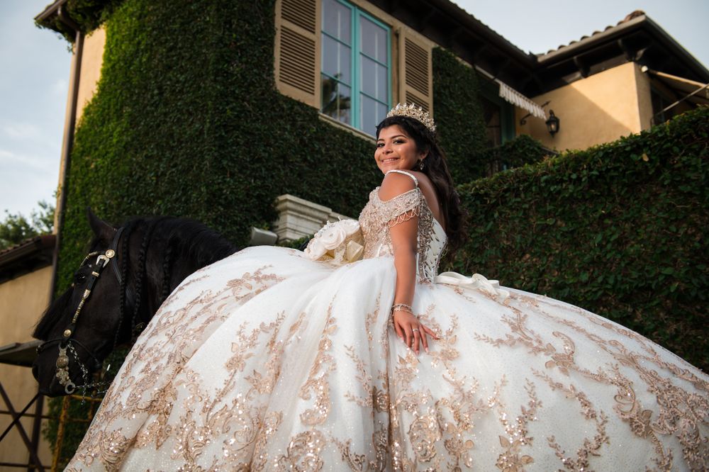 Luxurious champagne-colored ballgown showcased against an ivy-covered villa exterior.