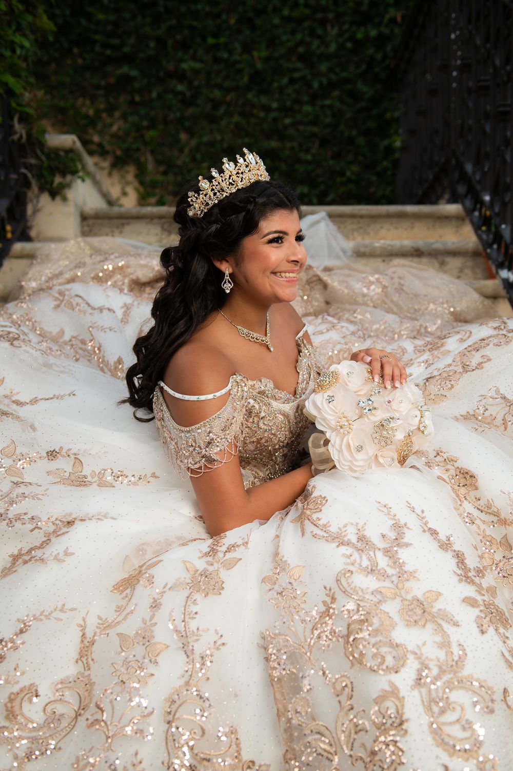 Elegant formal portrait featuring a detailed champagne-colored gown and golden crown.