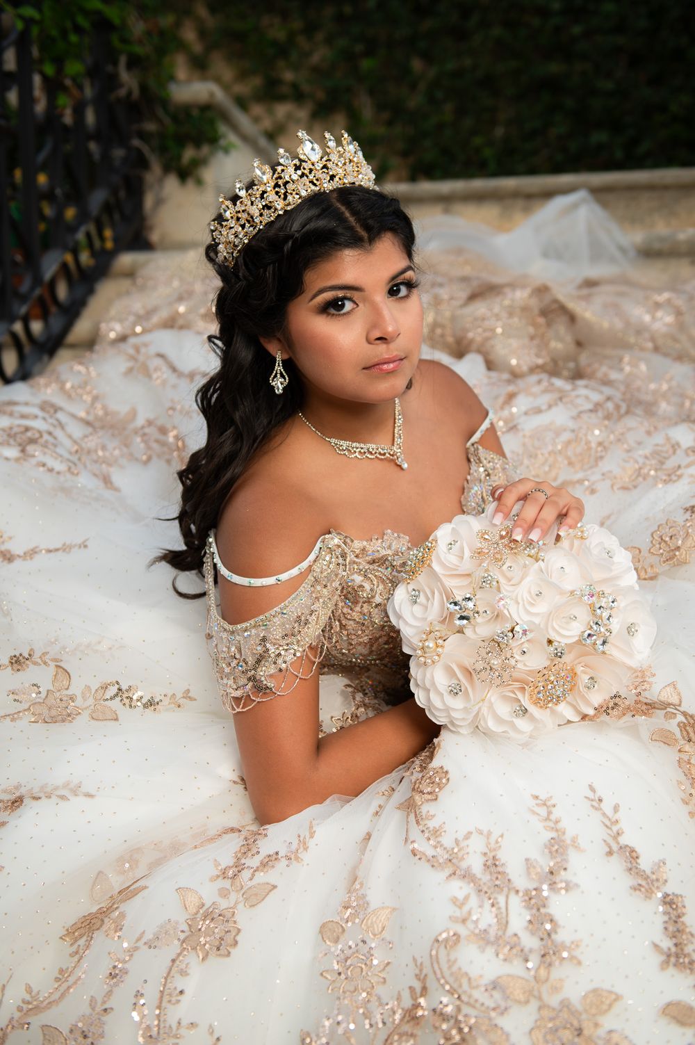Close-up portrait showcasing intricate crown and delicate off-shoulder gown details.