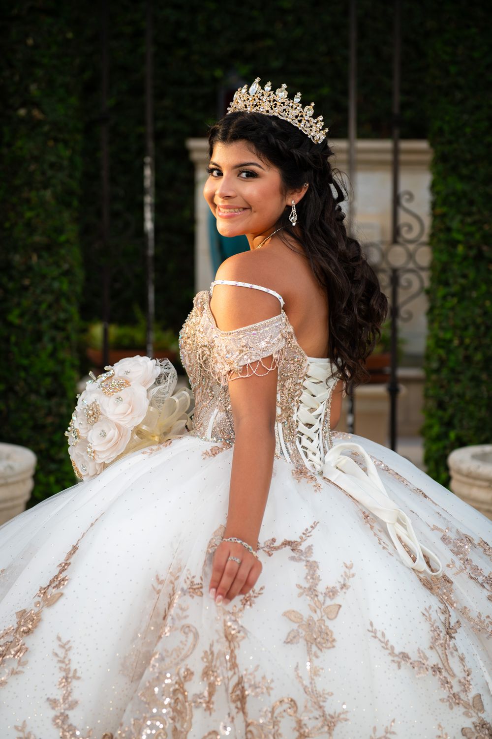 Stunning outdoor portrait featuring an elaborate ball gown and crystal crown.
