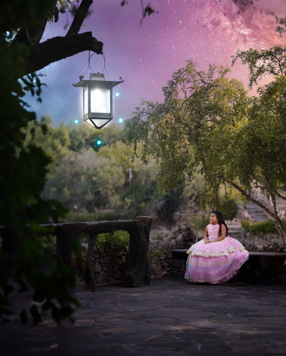 Enchanting scene with illuminated lantern and pink gown against twilight sky.