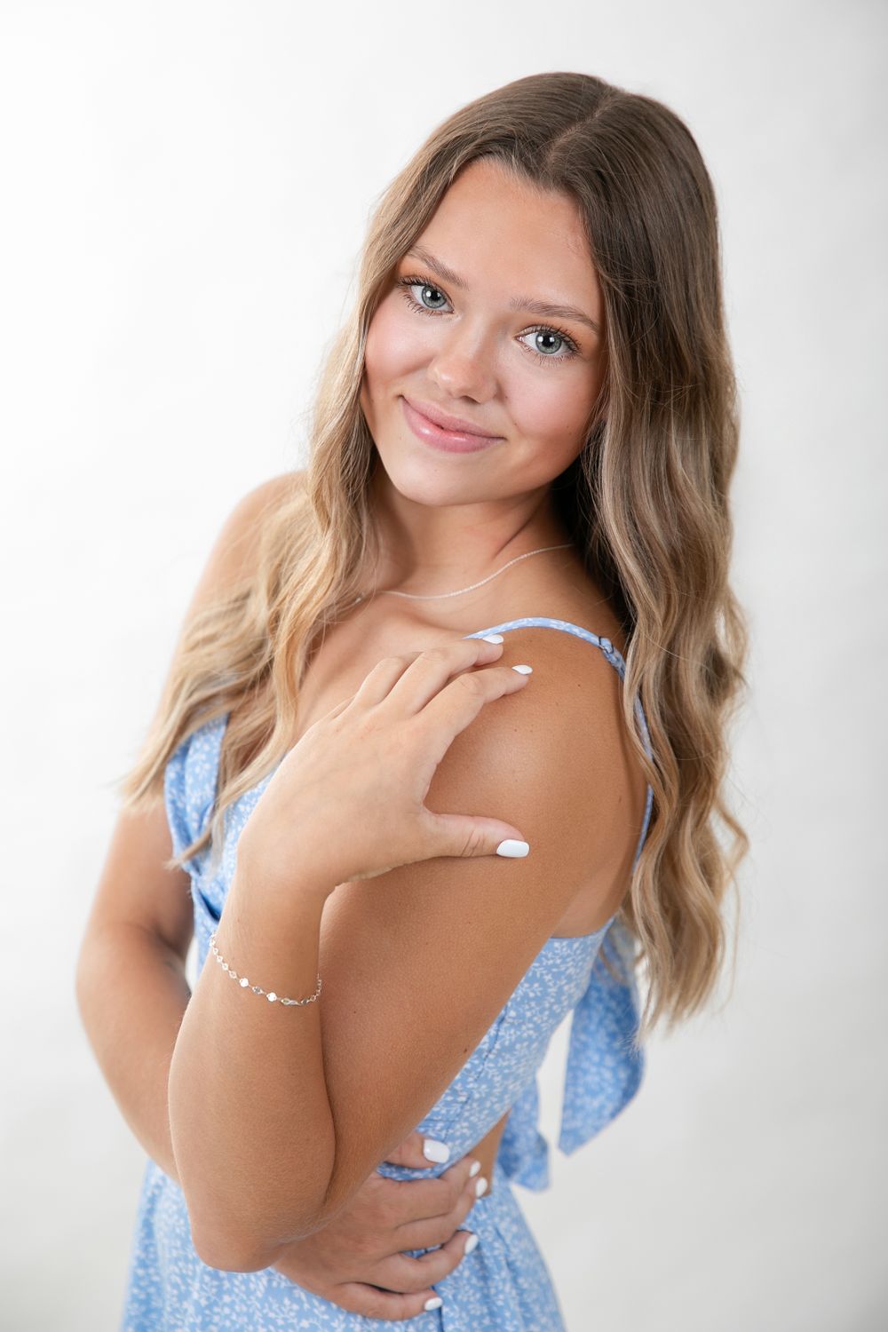 Portrait series showing a woman in a blue floral top against a white background.