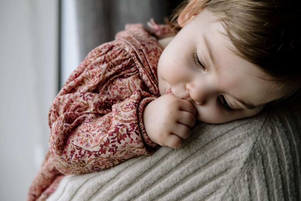 A peaceful moment of rest in a cozy pink patterned sweater.