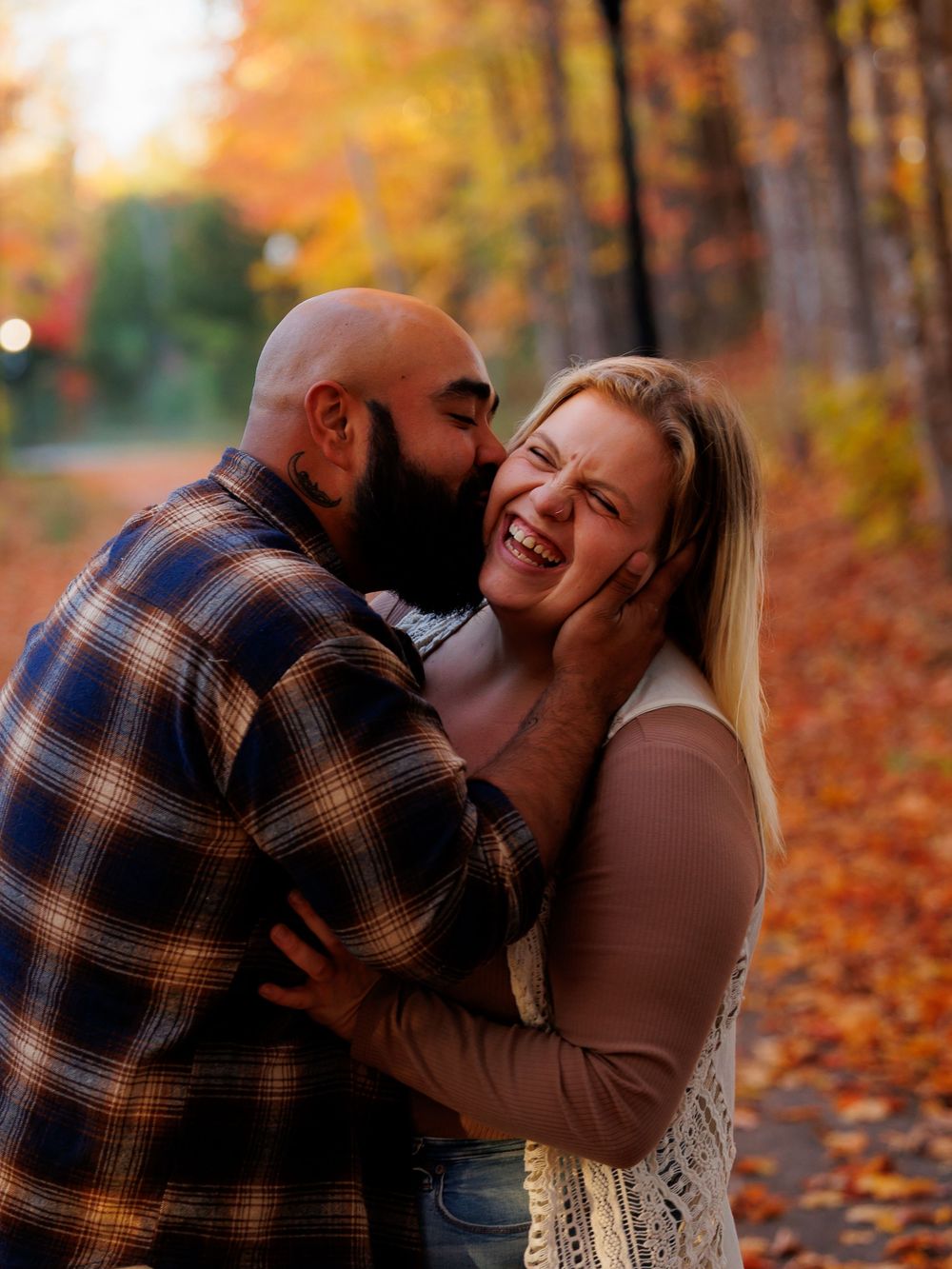A couple shares intimate moments in a series of autumn photos with fallen leaves in the background.