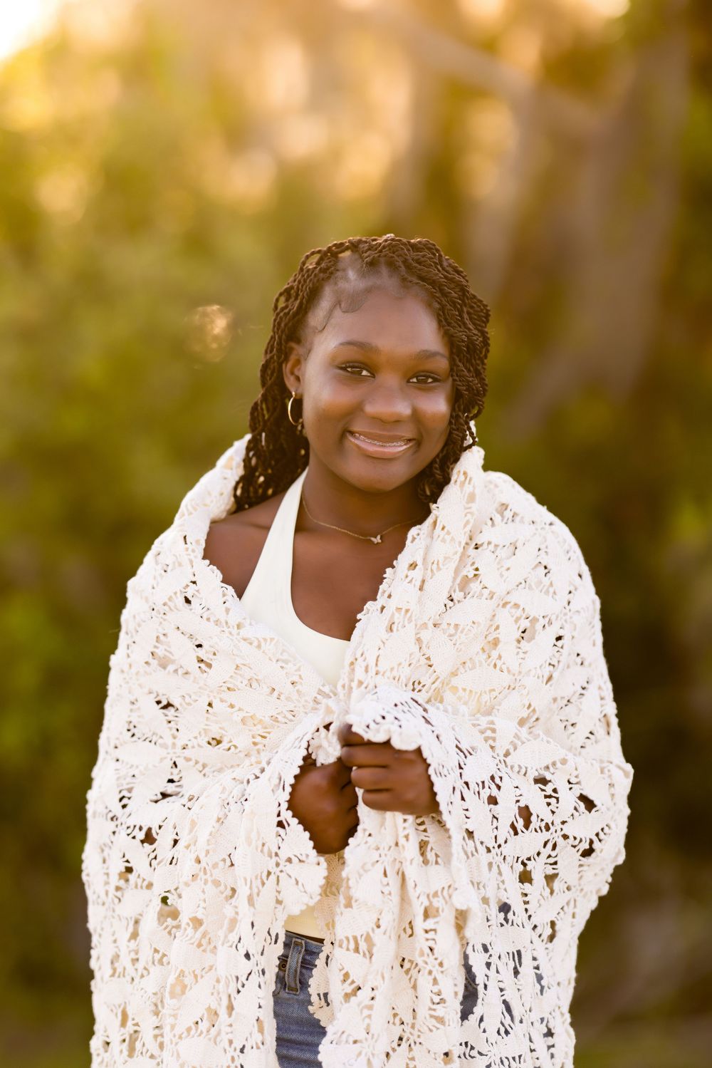 A warm portrait featuring a white lace cardigan against a sunset-lit natural backdrop. Photos by Tampa Photographer DigitalMyst Photography
